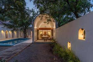 an external view of a house with a swimming pool at Le Casa Lion Resort A Premium Resort In Sasan Gir in Sasan Gir +82 photos