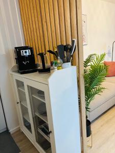 a small table with a refrigerator in a room at MINZ Studios in Bremen