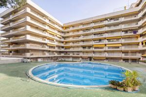 an external view of an apartment building with a swimming pool at Pet Friendly + Pool + Park, Beach 2 Minutes Away (Atalaya) in Salou