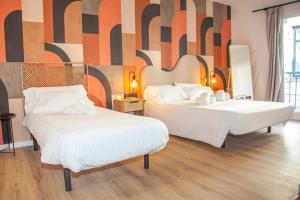 Ένα ή περισσότερα κρεβάτια σε δωμάτιο στο Kaixo Rooms