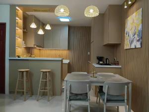 a kitchen with a table and two stools in it at Casathea Hometel Cebu in Talisay