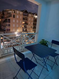 a table and two chairs on a balcony with a view at Canopia Sunset in Mamoudzou