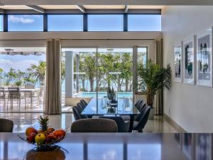 a dining room with a table and some chairs at Blue Views Penthouse Beachfront Apartment with Pool in Cape Town