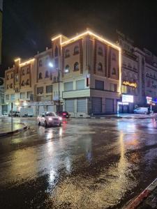 a car driving down a city street at night at OZ motel in Mechta el Hadj Douibi