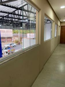 an empty hallway with a large window and a parking lot at Hotel Lorenna in Santa Inês +2 photos