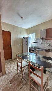 a kitchen with a table and chairs and a refrigerator at Hostel Tavares Bastos in Rio de Janeiro