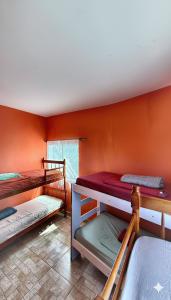 a room with three bunk beds in a room at Hostel Tavares Bastos in Rio de Janeiro