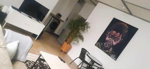 a living room with a tv and a potted plant at LM Loft Maboneng in Johannesburg