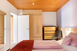 une chambre avec un lit avec un plafond en bois dans l'établissement Ferienwohnungen Im Löwengründle, à Unterkirnach