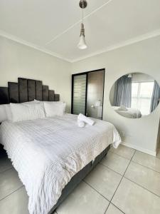 a bedroom with a large bed with a large mirror at The Blyde 104 in Pretoria +11 photos