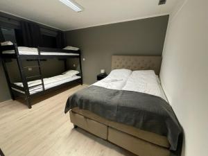 a bedroom with two bunk beds in a room at Ankenes Romutleie AS in Narvik