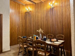 a dining room with a table and chairs at Casa Cedru in Ialoveni