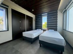 Postel nebo postele na pokoji v ubytování オーシャンフロントヴィラSerenity Point37