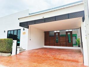 an open garage with a red floor and white walls at Le Villa Huahin in Ban Khao Rang +3 photos