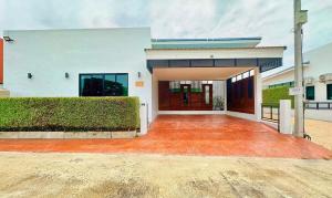 a large white building with a large driveway at Le Villa Huahin in Ban Khao Rang