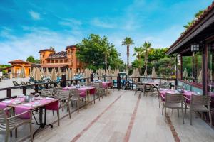 a row of tables and chairs on a patio at Villa Side Hotel in Side