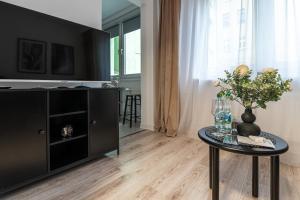 a living room with a table and a tv at Apartly - City Home &B in Szczecin