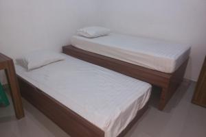 Voodi või voodid majutusasutuse Capital O 94901 Kostel Naga toas