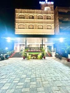 a large building with a fireplace in the middle of a patio at Pratima Heritage in Bhubaneshwar