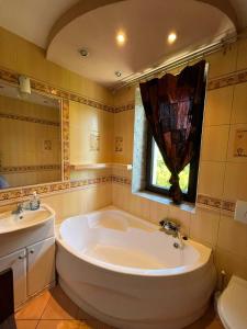 a bathroom with a large tub and a sink at Bałamutka B&B in Poronin +60 photos