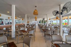 a restaurant with tables and chairs and a bar at Villa Side Hotel in Side
