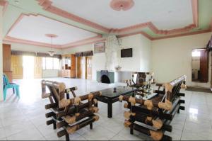 a large living room with a table and chairs at OYO 94936 Pondok Purnama in Ciwidey