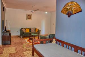 a living room with a couch and a table at MK Casa Modern 3BR Retreat Fully Furnished in Malindi
