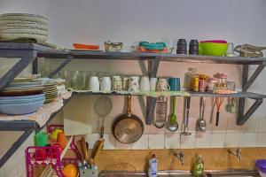 a kitchen with shelves filled with dishes and utensils at MK Casa Modern 3BR Retreat Fully Furnished in Malindi +12 photos