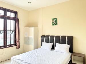 Postel nebo postele na pokoji v ubytování OYO 94897 Hotel Palapa