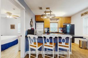 a kitchen with a table and chairs in a room at Neptunes Palace A1 in Saint George Island