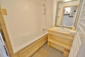 a bathroom with a tub and a sink at Refuge Les Echelles E4 in Le Grand-Bornand +11 photos