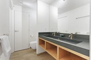 a bathroom with a sink and a toilet at Exclusive Duin Villa - 6p - Direct bij Natuur & Strand - Villa 70 in Ouddorp +54 photos