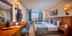 a hotel room with two beds and a desk at Villa Side Hotel in Side +42 photos