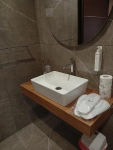 a bathroom with a white sink and a mirror at House Le Treemme in Chiubbica +11 photos