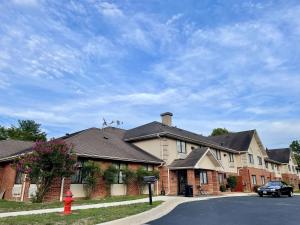a house with a red fire hydrant in front of it at SureStay by Best Western Prince Frederick in Prince Frederick