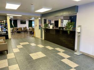 a lobby with a reception desk and a restaurant at SureStay by Best Western Prince Frederick in Prince Frederick