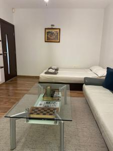 a living room with a couch and a coffee table at Modern Apartment in the Heart of Vidin in Vidin