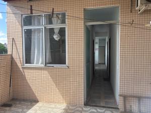 a brick building with a window and a hallway at Pousada São luis in Belém