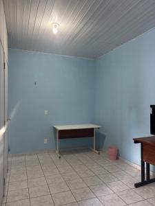 a table in a room with a white wall at Pousada São luis in Belém