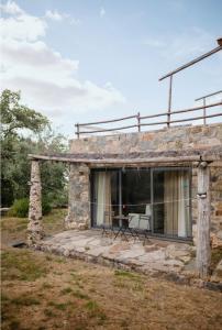 an old stone house with a patio at Monte das Mariolas in Castelo de Vide
