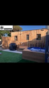 a view of a building with a patio and a yard at Le refuge sablais in Les Sables-dʼOlonne