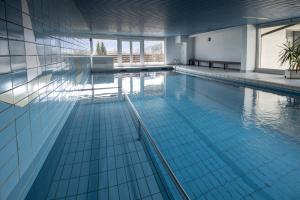 a large swimming pool in a building at Haus Mitterbach Ferienwohnung Bergkristall in Mitterbach +23 photos
