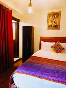 Ένα ή περισσότερα κρεβάτια σε δωμάτιο στο HOSTAl CUSCO-ECOTERRA