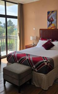 a bedroom with a large bed and a window at Authopia Hotel in Addis Ababa