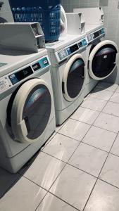 two washing machines sitting next to each other on a tile floor at Studio Albatros en RDJ avec Terrasse, Parking privé, Piscine, proche Golf St Donat in Mouans-Sartoux