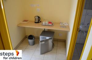 a small kitchen with a table and a sink at steps Self-Catering Accommodation in Okakarara