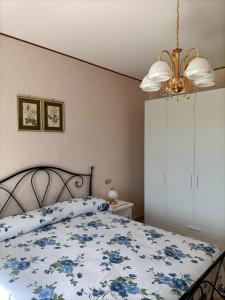 a bedroom with a bed with a blue and white comforter at Casa Bea in Castiglione