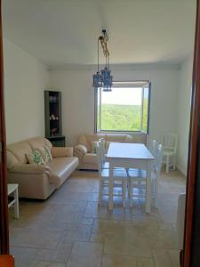 a living room with a table and a couch at Casa Bea in Castiglione