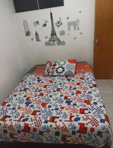 a bedroom with a bed with a quilt on it at Hotel mi casita in Bogotá +12 photos