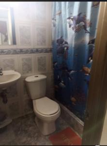 a bathroom with a toilet and a sink at Hotel mi casita in Bogotá